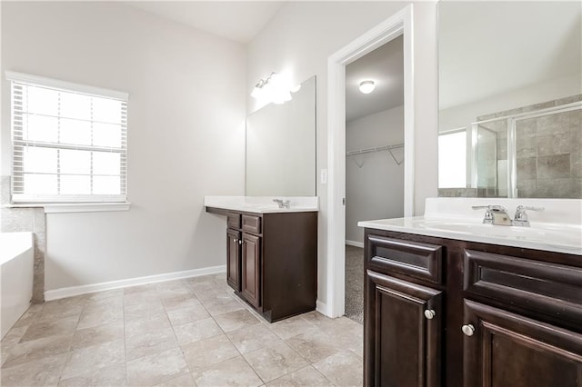 bathroom with vanity and separate shower and tub