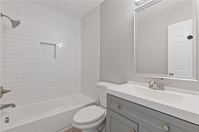 full bathroom with tiled shower / bath, vanity, and toilet