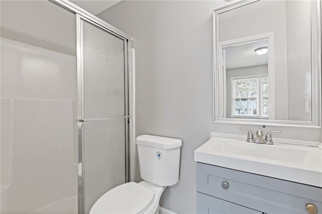 bathroom with vanity, toilet, and walk in shower