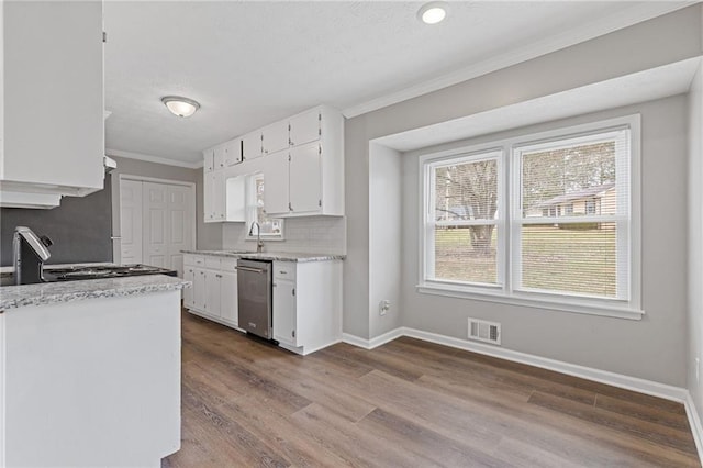 kitchen featuring dishwasher, sink, white cabinets, ornamental molding, and stove