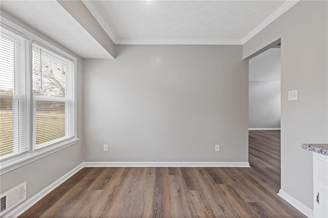 empty room with ornamental molding and dark hardwood / wood-style flooring