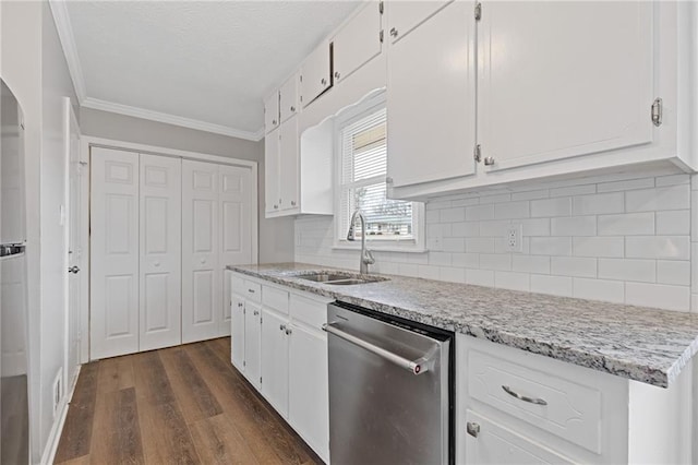 kitchen with dark hardwood / wood-style floors, white cabinetry, dishwasher, sink, and ornamental molding