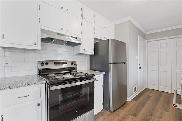 kitchen with ornamental molding, appliances with stainless steel finishes, hardwood / wood-style floors, and white cabinets