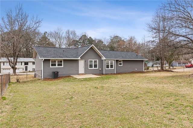 rear view of house featuring central AC, a patio area, and a lawn