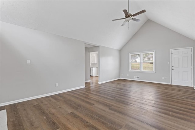 unfurnished living room featuring dark hardwood / wood-style flooring, high vaulted ceiling, and ceiling fan