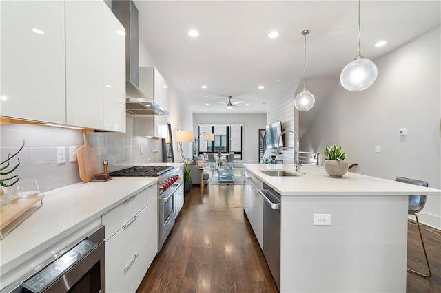 kitchen with stainless steel appliances, modern cabinets, a sink, and white cabinetry