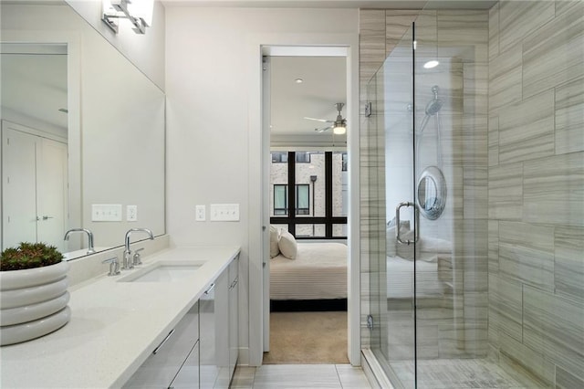 full bath featuring a stall shower, a ceiling fan, connected bathroom, and vanity