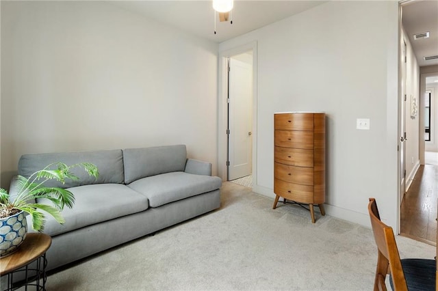 living area featuring ceiling fan, carpet, and visible vents