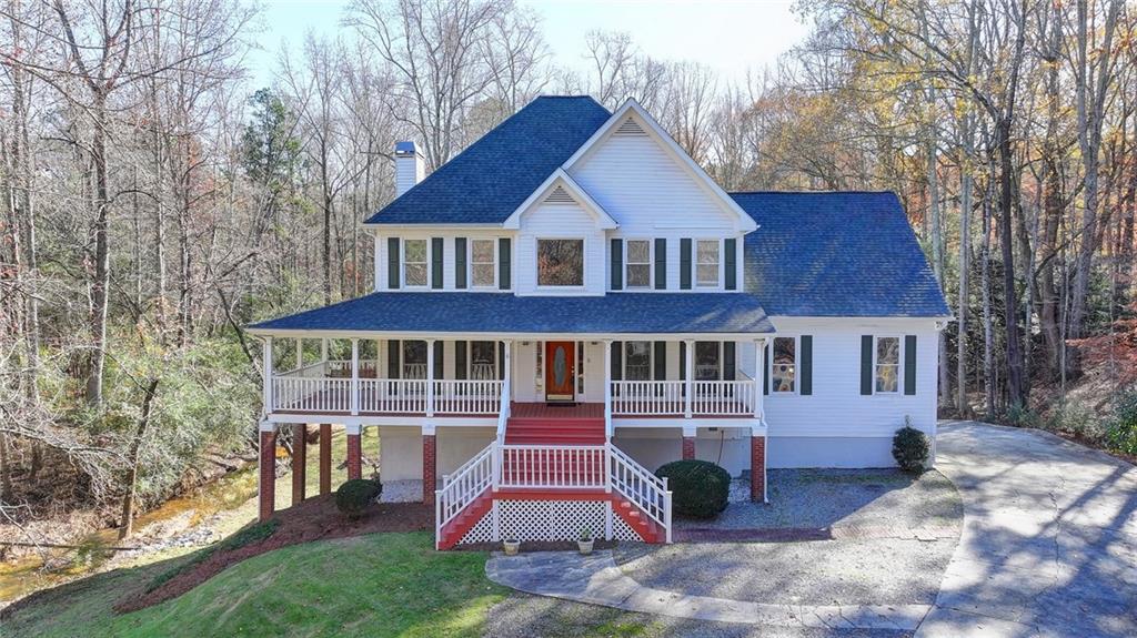 view of front of property with covered porch and a front yard