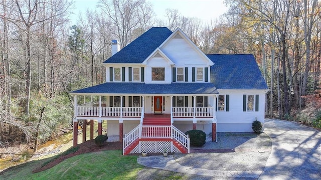 view of front of property with covered porch and a front yard