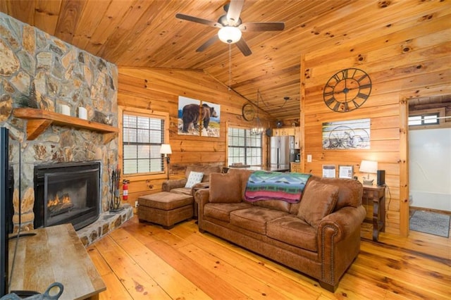 living area featuring wood ceiling, a wealth of natural light, wood walls, and light wood-style floors