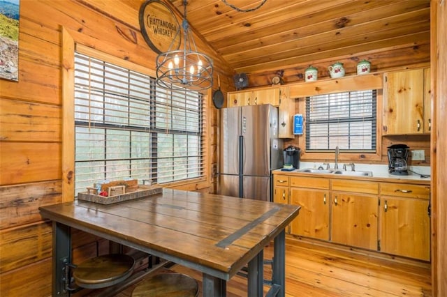 kitchen with a sink, light wood-type flooring, wood ceiling, lofted ceiling, and freestanding refrigerator