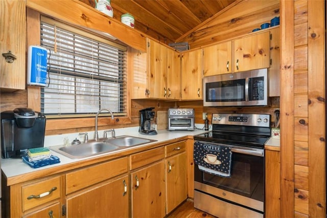 kitchen featuring lofted ceiling, light countertops, wooden ceiling, a sink, and appliances with stainless steel finishes