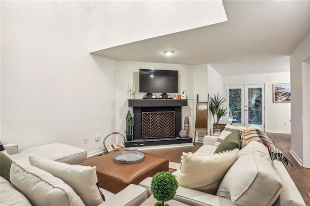 1209 Brookhaven Woods Ct NE, Brookhaven, GA 30319 - living area with wood finished floors, french doors, a fireplace with raised hearth, and baseboards
