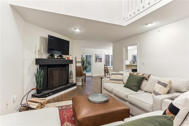 1209 Brookhaven Woods Ct NE, Brookhaven, GA 30319 - living room with wood finished floors, a fireplace with raised hearth, and baseboards
