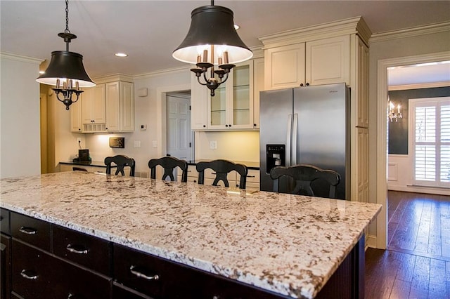 kitchen featuring stainless steel fridge with ice dispenser, dark hardwood / wood-style floors, crown molding, and pendant lighting