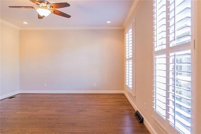 empty room with ceiling fan, dark hardwood / wood-style flooring, and ornamental molding