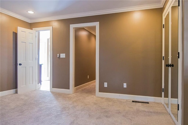 unfurnished room with light colored carpet and ornamental molding