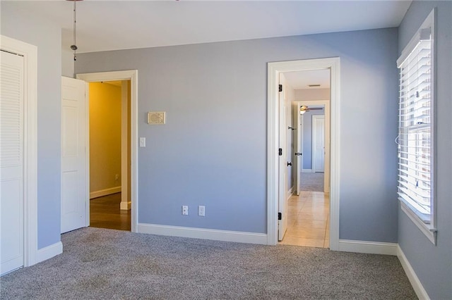 unfurnished bedroom with light carpet and multiple windows