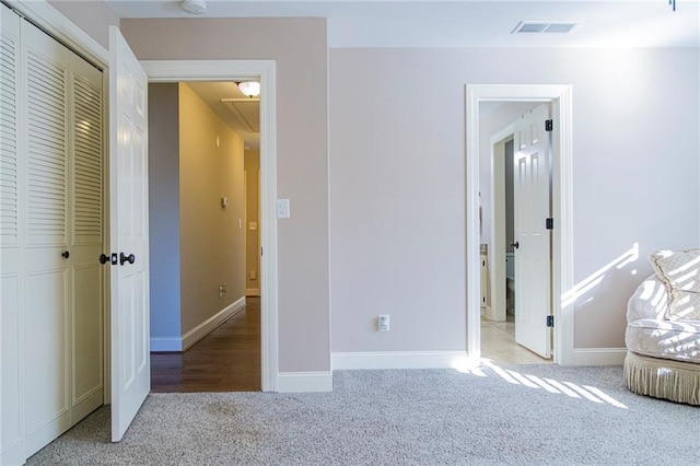 unfurnished bedroom featuring a closet and carpet floors