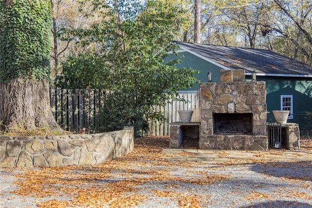 exterior space with an outdoor stone fireplace