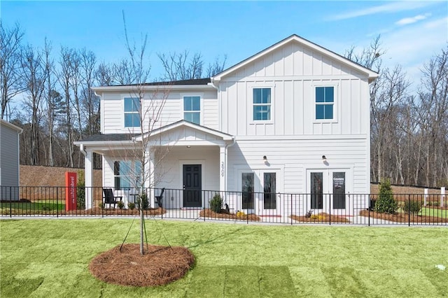 view of front of home with french doors, a front lawn, and covered porch