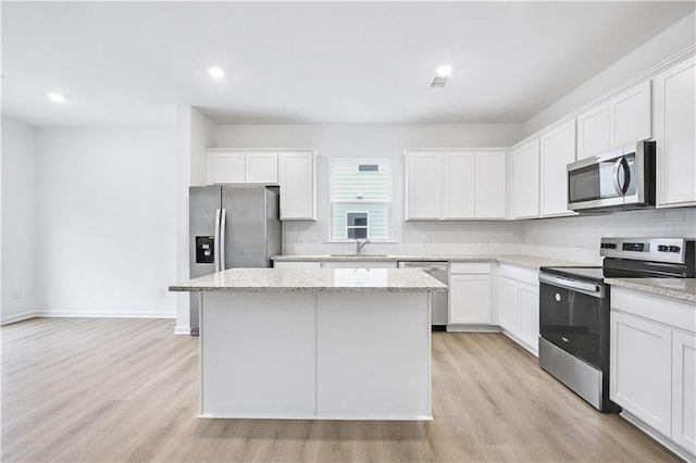 kitchen featuring appliances with stainless steel finishes, sink, and white cabinets