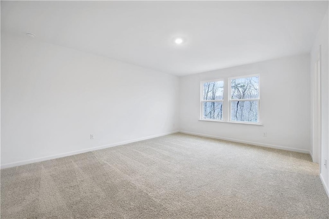 unfurnished room with light colored carpet