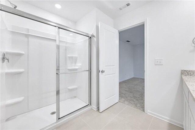 bathroom featuring vanity, tile patterned floors, and walk in shower