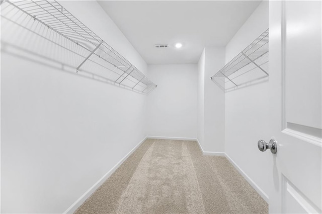 walk in closet with carpet