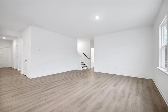 empty room with light hardwood / wood-style floors