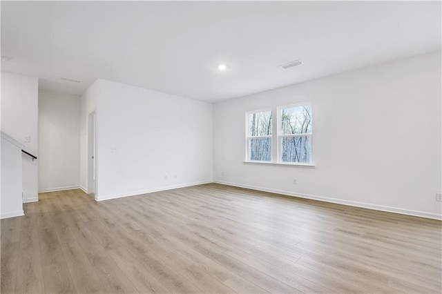 empty room with light hardwood / wood-style floors