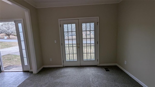 entryway with visible vents, french doors, crown molding, and carpet floors