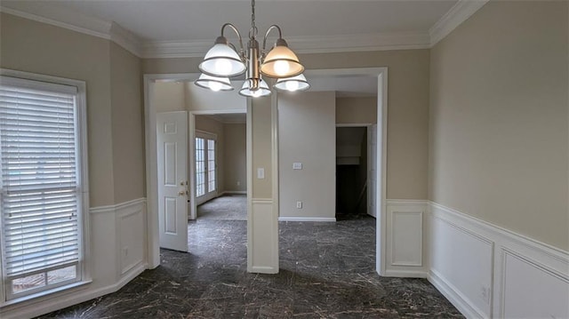 unfurnished dining area featuring a decorative wall, ornamental molding, marble finish floor, and wainscoting