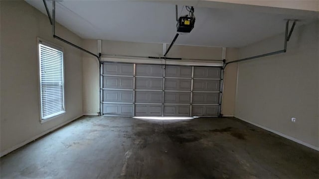 garage with a garage door opener and baseboards