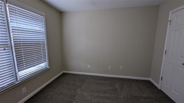 spare room featuring baseboards and carpet floors