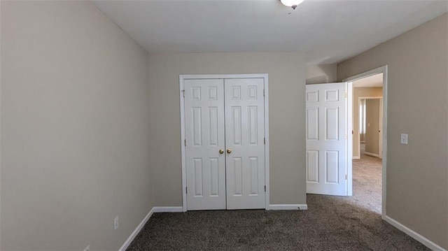 unfurnished bedroom with baseboards, a closet, and carpet floors