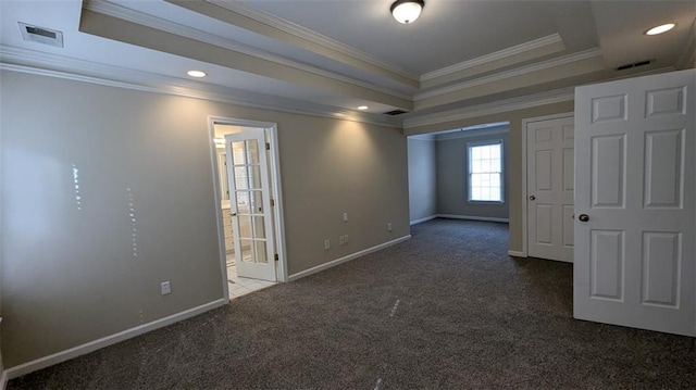 carpeted empty room featuring visible vents, ornamental molding, recessed lighting, baseboards, and a raised ceiling