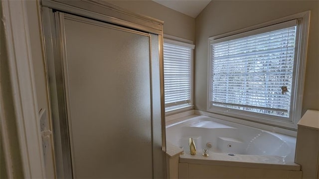 full bathroom featuring a stall shower and a jetted tub