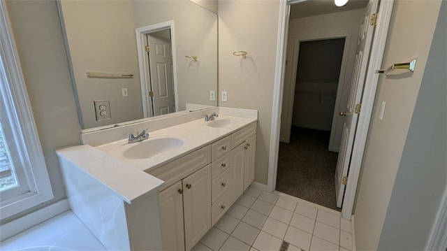 bathroom with a sink, double vanity, and tile patterned floors