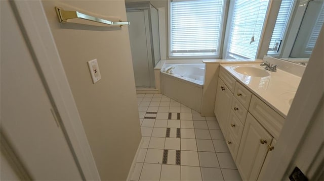 full bathroom with double vanity, a sink, tile patterned flooring, a shower stall, and a garden tub