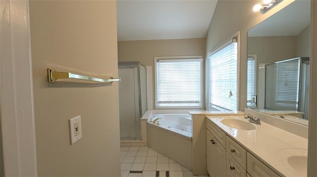 full bathroom with double vanity, a stall shower, a sink, tile patterned flooring, and a garden tub