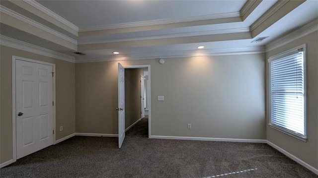 spare room featuring a tray ceiling, baseboards, and carpet flooring