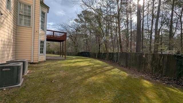 view of yard featuring cooling unit, fence, and a wooden deck