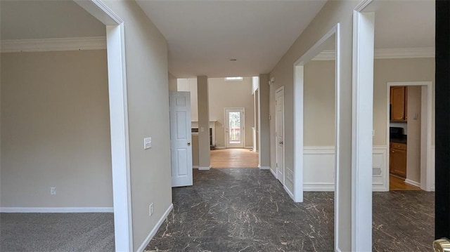 hall with baseboards, marble finish floor, and crown molding