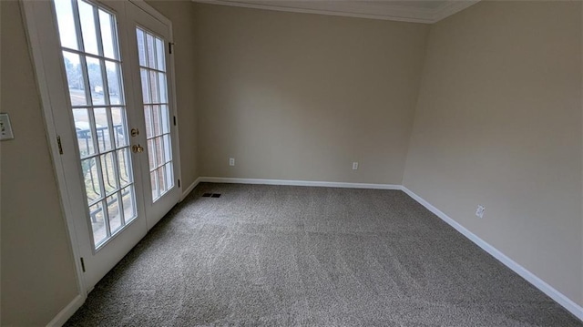 unfurnished room with plenty of natural light, dark carpet, french doors, and baseboards