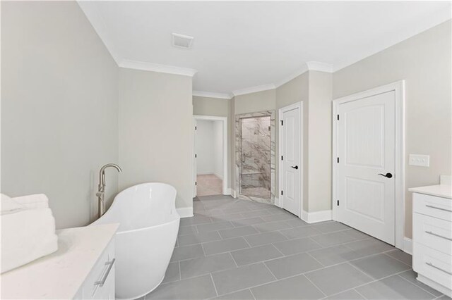 bathroom featuring vanity, a bathtub, crown molding, and tile patterned floors