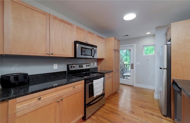2023 Oakview Rd SE Unit 226, Atlanta, GA 30317 - kitchen featuring stainless steel appliances, light brown cabinetry, light wood-style floors, dark stone counters, and recessed lighting