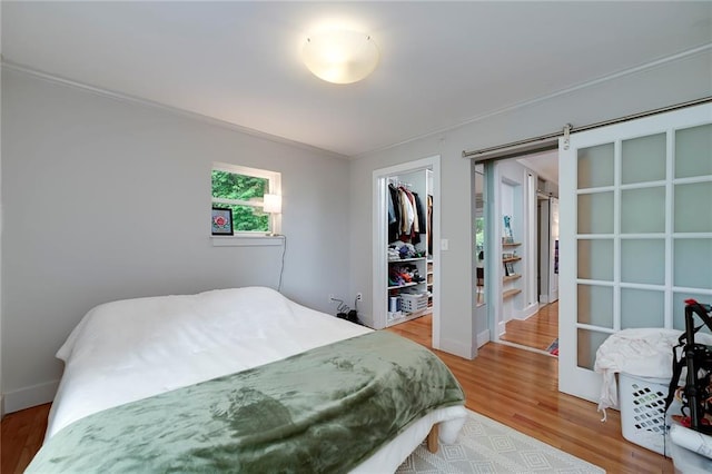 2023 Oakview Rd SE Unit 226, Atlanta, GA 30317 - bedroom featuring wood finished floors, crown molding, and a closet