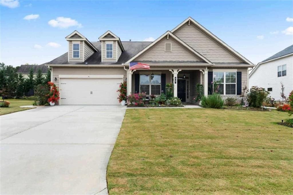 view of front of property featuring a garage and a front lawn